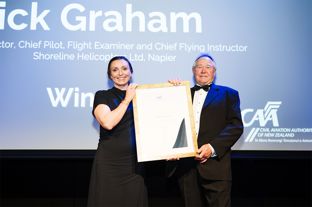 Acting Director of Civil Aviation, Catherine MacGowan, presents Rick Graham with his Award.