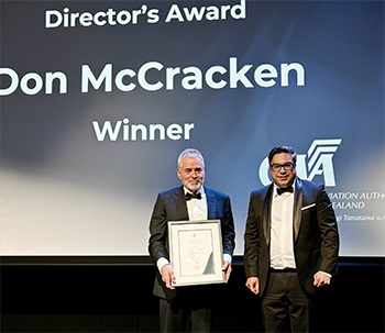 Dan receives his award from Kane