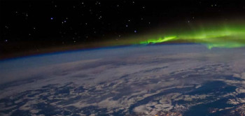 Earth from space with green aurora