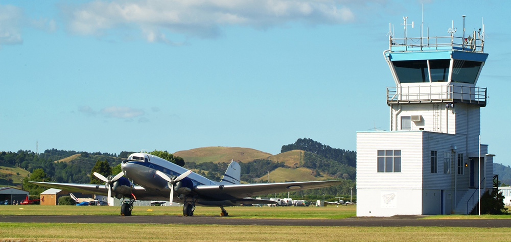 Small plane beside control tower