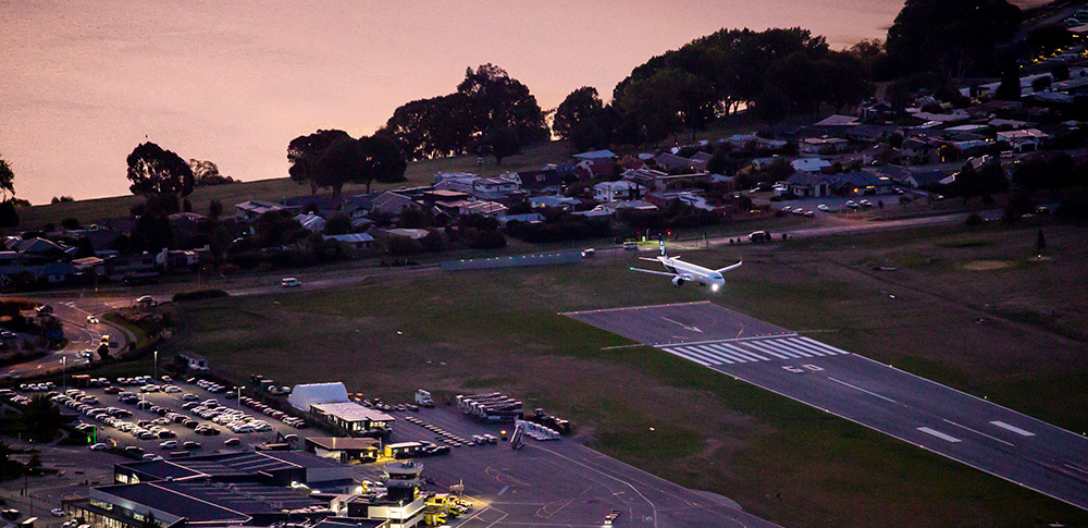 Plane landing at dusk in Queenstown