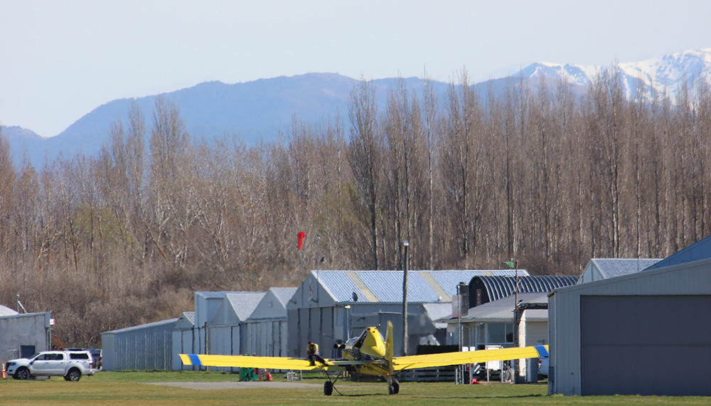 Small yellow plane, mountains in background