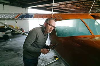 Man standing beside plane