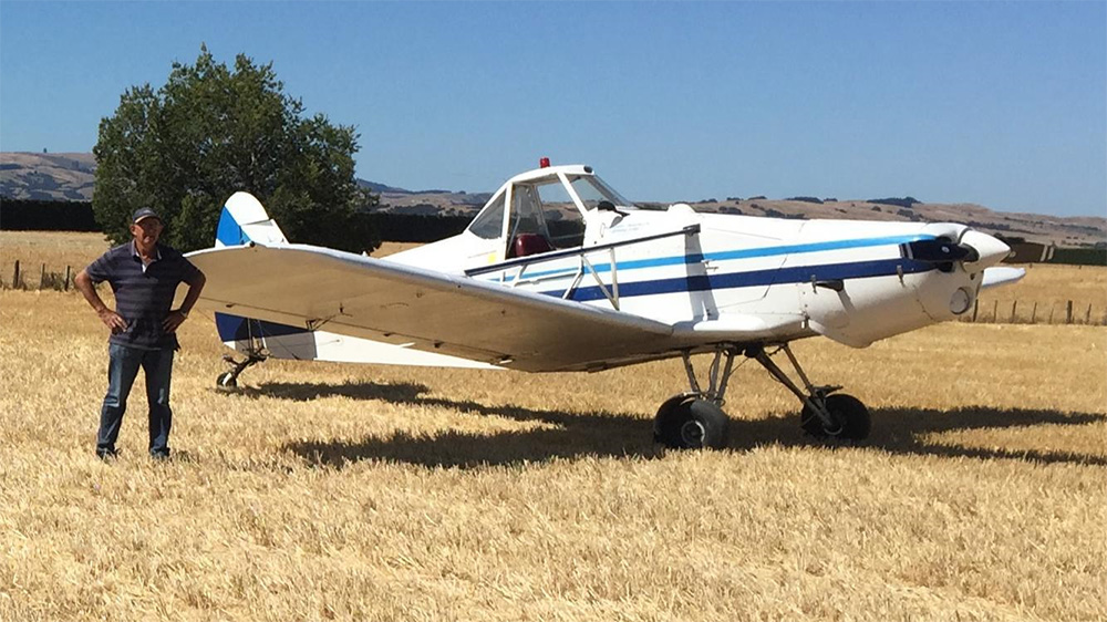 Ronald standing beside plane