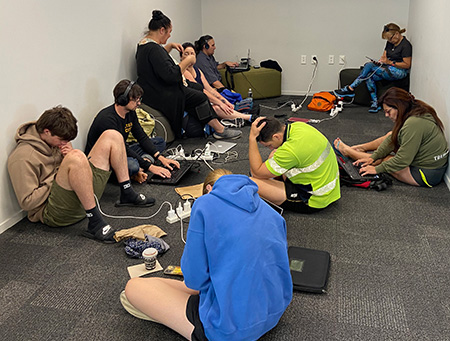 People charging devices at airport.