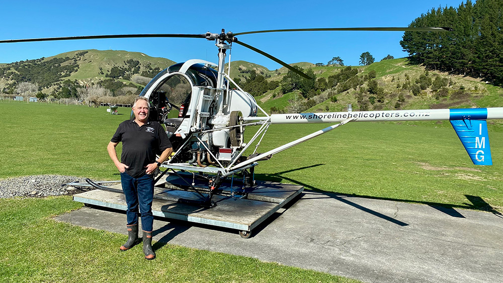 Rick standing besides his helicopter.