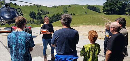 Emma Tilyard, Safety Manager for V3 Heli Ltd, giving a safety briefing to passengers.