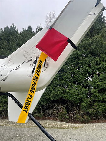 Plane with 'Remove before flight' ribbon