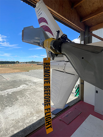 Plane tail with 'Remove before flight' ribbon