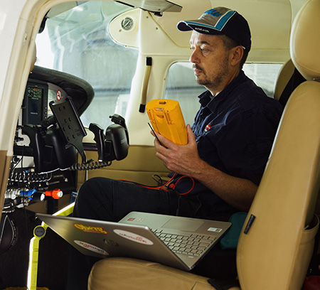 Engineer sitting in cockpit of small plane