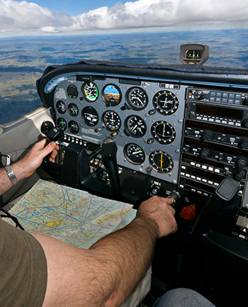 Pilot in cockpit with map on lap