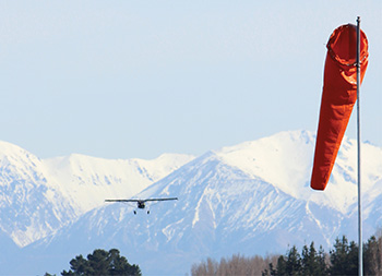 Distant plane with mountains in the background/