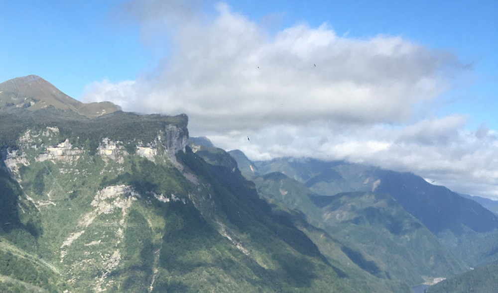 Wind flowing across mountainous terrain often induces cloud formation.