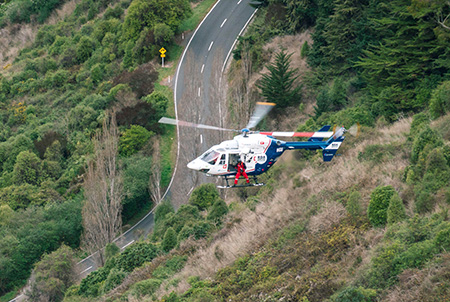 A BK117 / H145 rescue helicopter on its way to the driver of a vehicle which left the road and fell down a steep bush-covered hill in Christchurch in 2020.